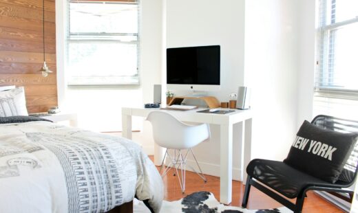 white wooden desk near bed inside the room